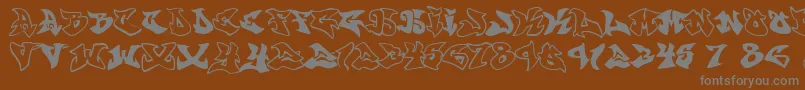 Шрифт Graffonti.Atomic.Bomb.Fontvir.Us – серые шрифты на коричневом фоне