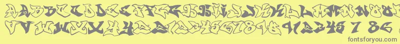 Graffonti.Atomic.Bomb.Fontvir.Us-fontti – harmaat kirjasimet keltaisella taustalla