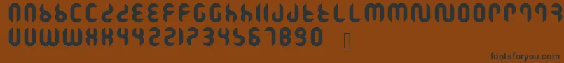 フォントRamasuri – 黒い文字が茶色の背景にあります