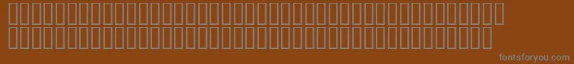 Czcionka LinotypeAfrikaOne – szare czcionki na brązowym tle