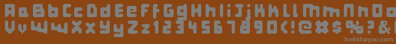 Fatpixel-fontti – harmaat kirjasimet ruskealla taustalla
