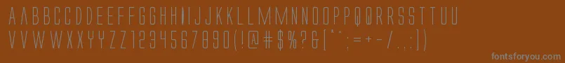 Alienleague-fontti – harmaat kirjasimet ruskealla taustalla