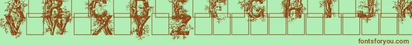 Fonte Deepwoodsinitials – fontes marrons em um fundo verde
