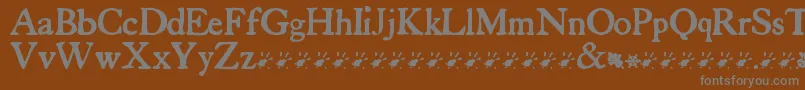 フォントTuersCardboard – 茶色の背景に灰色の文字