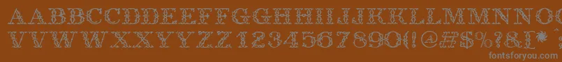 Antique-fontti – harmaat kirjasimet ruskealla taustalla