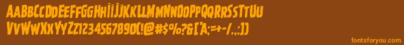フォントGhoulishintentrotal – オレンジ色の文字が茶色の背景にあります。