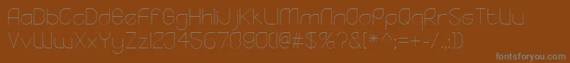 YodoLight-fontti – harmaat kirjasimet ruskealla taustalla