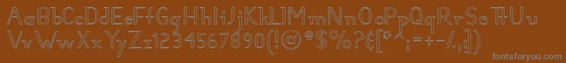HunterHollow-fontti – harmaat kirjasimet ruskealla taustalla