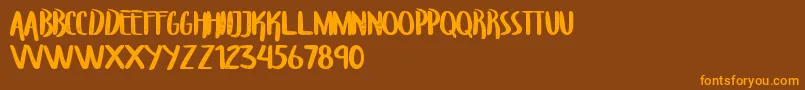 Fonte TroupersCapitals – fontes laranjas em um fundo marrom