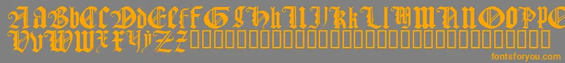 フォントGothicTextureQuadrata – オレンジの文字は灰色の背景にあります。