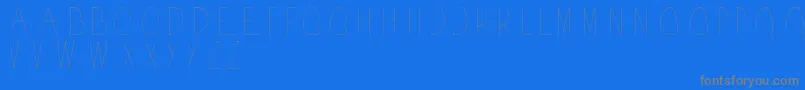 Acorn-fontti – harmaat kirjasimet sinisellä taustalla