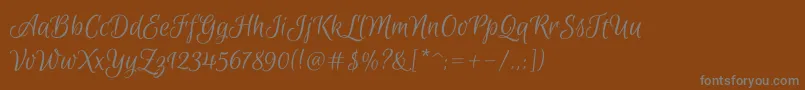 EuphoriascriptRegular-fontti – harmaat kirjasimet ruskealla taustalla