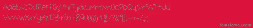 Cutehandwriting-fontti – harmaat kirjasimet punaisella taustalla