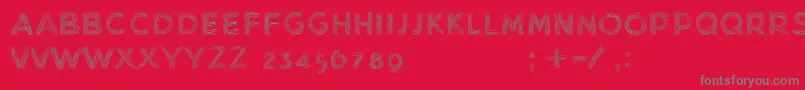 MinkdemoBold-fontti – harmaat kirjasimet punaisella taustalla