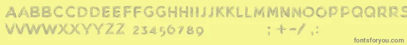 MinkdemoBold-fontti – harmaat kirjasimet keltaisella taustalla