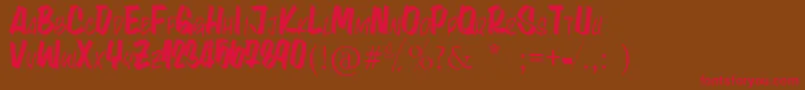フォントLynaKety – 赤い文字が茶色の背景にあります。