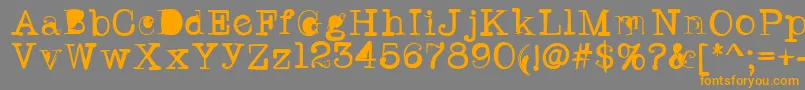 フォントTwritertwo – オレンジの文字は灰色の背景にあります。