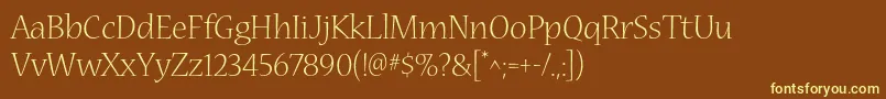 NuevastdLight-fontti – keltaiset fontit ruskealla taustalla