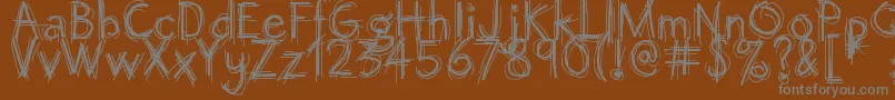 Octemberscript-Schriftart – Graue Schriften auf braunem Hintergrund