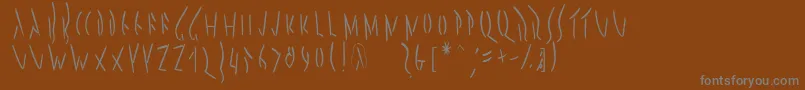 Pompejimk-fontti – harmaat kirjasimet ruskealla taustalla