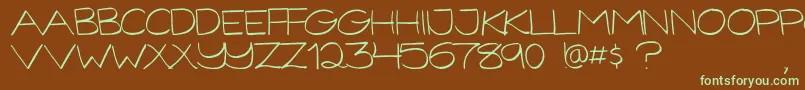 フォントGorillaComixLight – 緑色の文字が茶色の背景にあります。