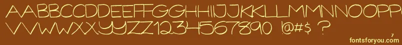 GorillaComixLight-fontti – keltaiset fontit ruskealla taustalla