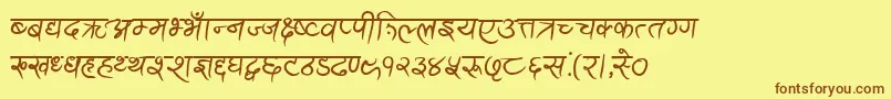 フォントAnandaAkchyarBold – 茶色の文字が黄色の背景にあります。