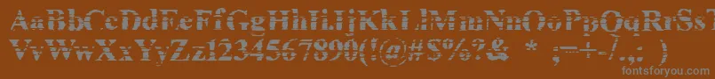 Cheapink-fontti – harmaat kirjasimet ruskealla taustalla