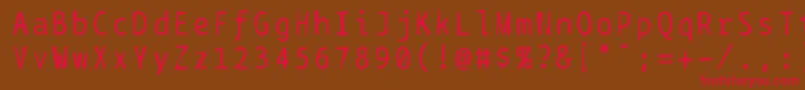フォントBptypewritedamaged – 赤い文字が茶色の背景にあります。