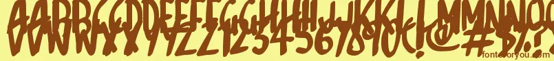 フォントSketchalot – 茶色の文字が黄色の背景にあります。
