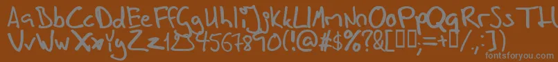 Inhishan-fontti – harmaat kirjasimet ruskealla taustalla