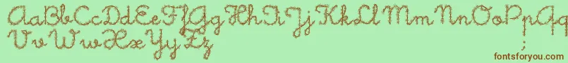 フォントLittleDaisy – 緑の背景に茶色のフォント