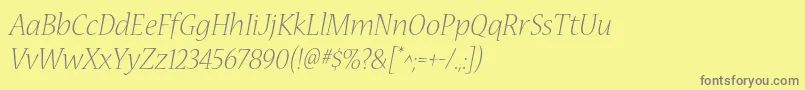 フォントNuevastdLightitalic – 黄色の背景に灰色の文字