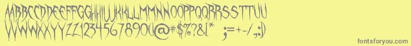 フォントUnquietSpirits – 黄色の背景に灰色の文字
