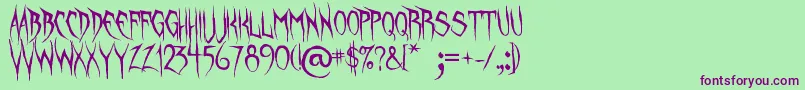 フォントUnquietSpirits – 緑の背景に紫のフォント