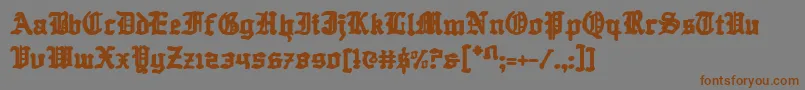 フォントQuestknight – 茶色の文字が灰色の背景にあります。