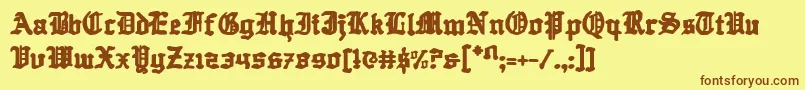 フォントQuestknight – 茶色の文字が黄色の背景にあります。