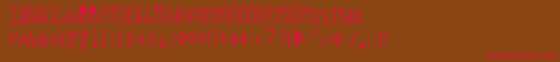 フォントRetrogenious – 赤い文字が茶色の背景にあります。