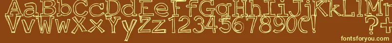 JustAnOutty-fontti – keltaiset fontit ruskealla taustalla