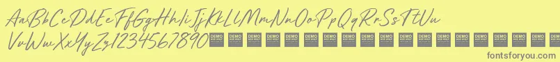 フォントFutureShockDemo – 黄色の背景に灰色の文字