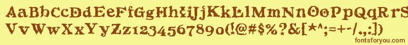 フォントBeltane – 茶色の文字が黄色の背景にあります。