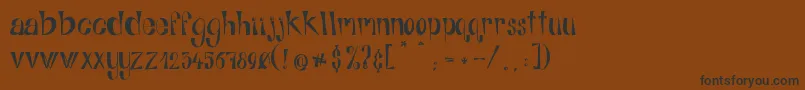 AlphabitsRegular-Schriftart – Schwarze Schriften auf braunem Hintergrund
