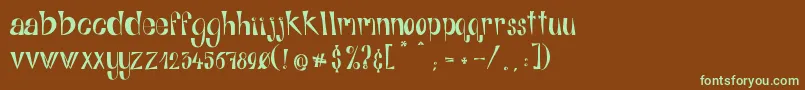 フォントAlphabitsRegular – 緑色の文字が茶色の背景にあります。