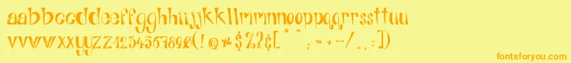 フォントAlphabitsRegular – オレンジの文字が黄色の背景にあります。