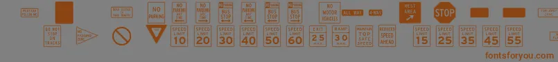 フォントInterstatepiTwo – 茶色の文字が灰色の背景にあります。