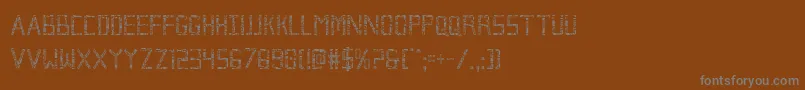 Brokencyborgcond-fontti – harmaat kirjasimet ruskealla taustalla