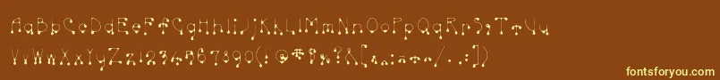 Skinnydrip-Schriftart – Gelbe Schriften auf braunem Hintergrund