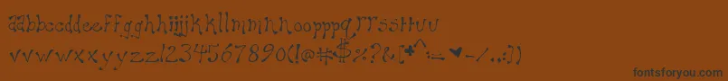 フォントMaryellen – 黒い文字が茶色の背景にあります