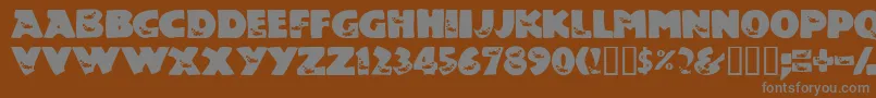 TouchOfNature-fontti – harmaat kirjasimet ruskealla taustalla