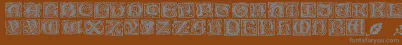 MorrisJensonInitialen-fontti – harmaat kirjasimet ruskealla taustalla
